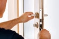 Man repairing the lock of door.