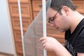 Man repairing mosquito net at home. Home improvement concept Royalty Free Stock Photo