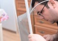 Man repairing mosquito net at home. Home improvement concept Royalty Free Stock Photo