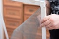 Man repairing mosquito net at home. Home improvement concept Royalty Free Stock Photo