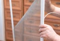 Man repairing mosquito net at home. Home improvement concept Royalty Free Stock Photo