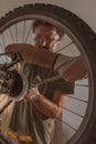 Man repairing old mountain bike in workshop