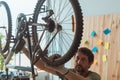 Man repairing old mountain bike in workshop