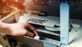 A man is repairing a printer. digital photocopier machine