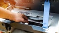 A man is repairing a printer. digital photocopier machine. printing equipment, 3d scanner
