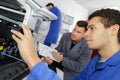 Man repairing printer in professional school