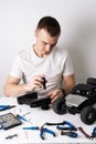 Man repairing a radio-controlled model car buggy. On the table are tools for repair. Royalty Free Stock Photo