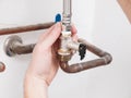 Man repairing a safety valve of an electric boiler