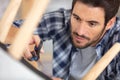 man repairing stool and using scissors Royalty Free Stock Photo