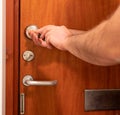 Man repairing wooden door lock with screwdriver. Close-up of repairing Royalty Free Stock Photo