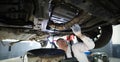 Man repairman fixing car in workshop closeup Royalty Free Stock Photo