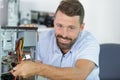 Man repairman trying to fix pc Royalty Free Stock Photo