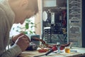 Man repairman is trying to fix using the tools on the computer that is on a workplace in the office Royalty Free Stock Photo