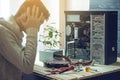 Man repairman is trying to fix using the tools on the computer that is on a workplace in the office Royalty Free Stock Photo