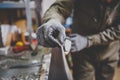 A man repairman in workshop ski service repairing the sliding surface of the ski at Ski vise. In hands of instrument Final edge