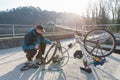 Man repairs a bicycle with flat tire. Concept of unforeseen