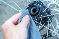 A man repairs a bicycle wheel.