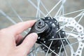 A man repairs a bicycle wheel.