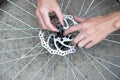 A man repairs a bicycle wheel