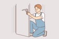 Man repairs door by changing lock to prevent criminals from entering apartment or home Royalty Free Stock Photo