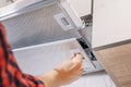 Man repairs hood in kitchen. Replacement filter in cooker hood Royalty Free Stock Photo