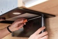Man repairs hood in kitchen. Replacement filter in cooker hood Royalty Free Stock Photo