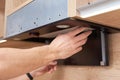 Man repairs hood in kitchen. Replacement filter in cooker hood Royalty Free Stock Photo