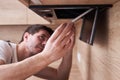 Man repairs hood in kitchen. Replacement filter in cooker hood Royalty Free Stock Photo