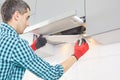Man repairs range hood in the kitchen. Replacement filter in a cooker hood. Royalty Free Stock Photo