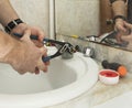 a man repairs an old faucet in the bathroom Royalty Free Stock Photo