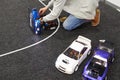 Man repairs radio-controlled car on race track Royalty Free Stock Photo