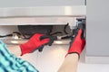 Man repairs range hood in the kitchen. Replacement filter in a cooker hood