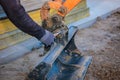 A man repairs a tractor bucket, changes the mounting sleeve. Replacing the nozzle on the tractor boom. Close-up.