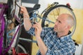 Man reparing bike in bicycle repair shop