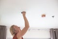 A man replaces an LED light bulb in a ceiling light Royalty Free Stock Photo