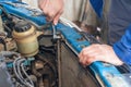 A man replaces an old broken radiator in a car with a new one Royalty Free Stock Photo