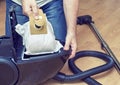 Man replacing a dust bag in vacuum cleaner Royalty Free Stock Photo