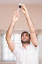 Man replacing the light bulb Royalty Free Stock Photo