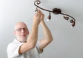 Man replacing the light bulb at home Royalty Free Stock Photo