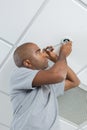 Man replacing spotlight bulb Royalty Free Stock Photo