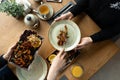 A man in a restaurant looks after a woman and puts food on her plate. Royalty Free Stock Photo