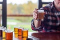 Man at a restaurant sampling beer from a beer flight