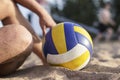 A man resting after a game of volleyball sitting on the sand, ne Royalty Free Stock Photo