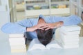 Man resting head between two piles books Royalty Free Stock Photo