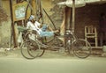 A man resting in his rikshaw after work in ganganagar, india