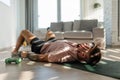 Man resting after home workout, New Year's resolutions, exercising as healthy lifestyle and selfcare. Concept of