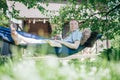 A man is resting and reading in a hammock. Day off and relaxation