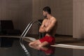 Man Resting Relaxed On Edge Of Swimming Pool Royalty Free Stock Photo