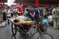 Man resting on a rickshaw of the Panjiayuan Antique Market, Beijing