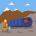 Man resting in sleeping bag in the mountains.